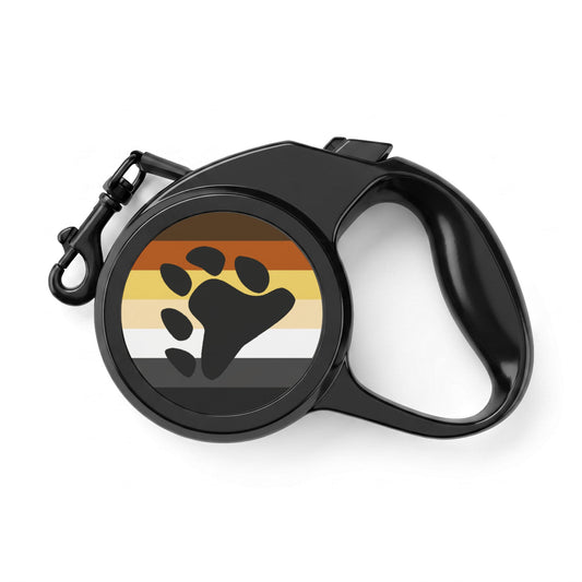 A black retractable dog leash with a circular cover featuring a black paw print over horizontal stripes in brown, orange, yellow, white, and black, on a white background.