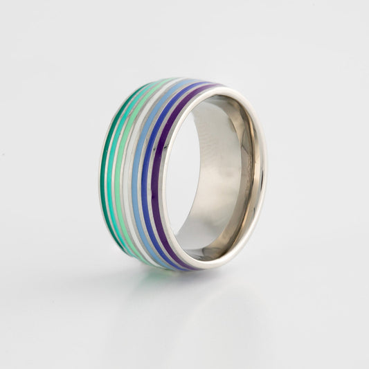 Silver ring with gay mlm pride flag colored stripes on a light gray background