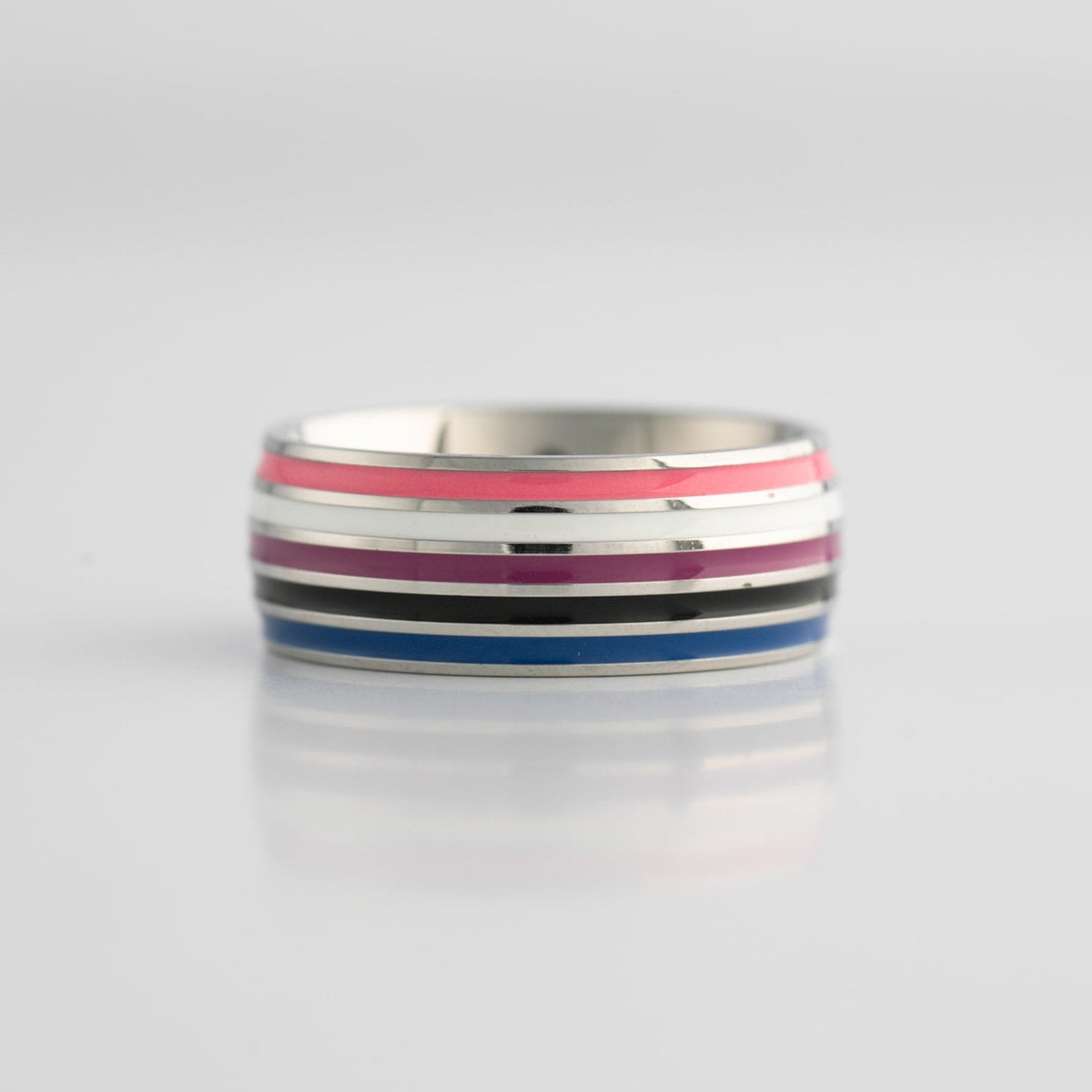 Silver ring with colorful genderfluid pride flag stripes on a light gray background