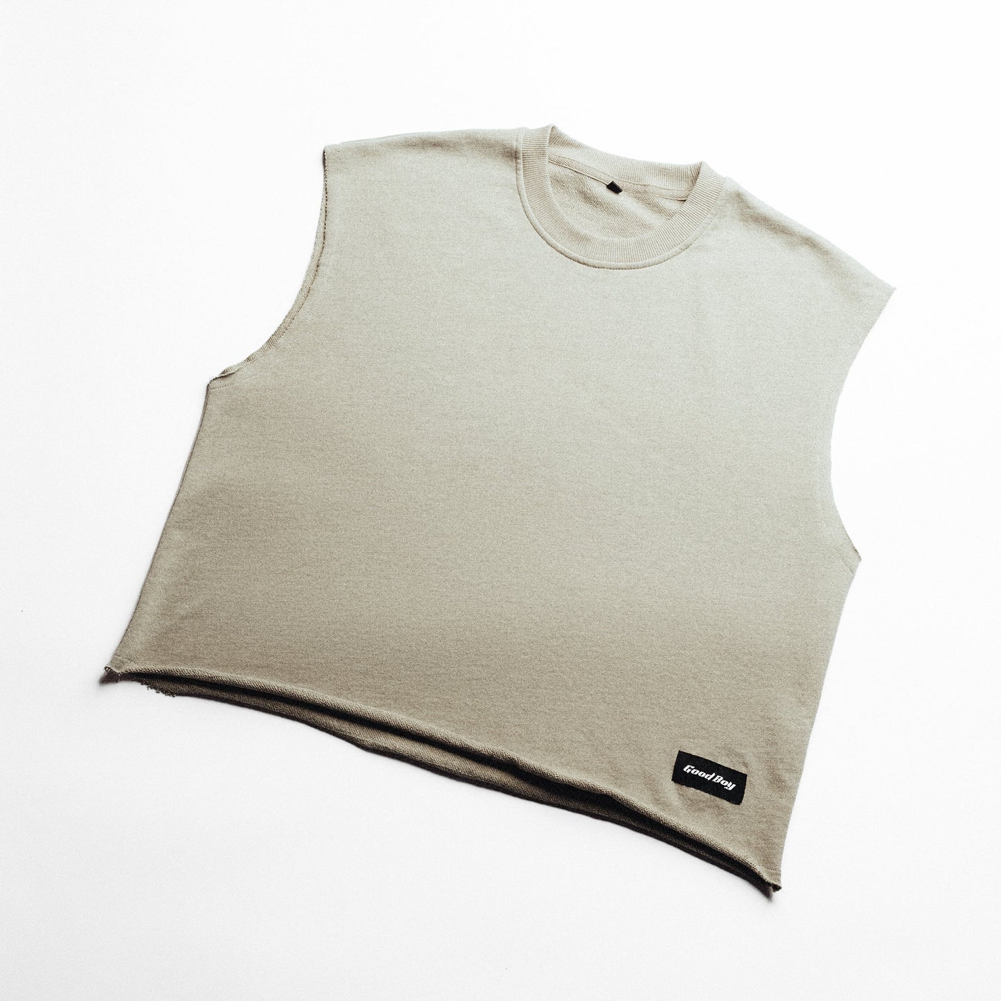 Ivory sleeveless shirt with a 'Good Boy' logo on a white background