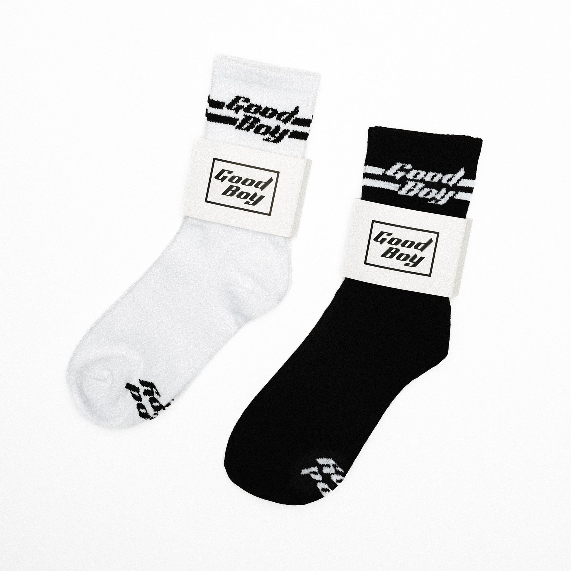 Two pair of socks, one white and one black, with 'Good Boy' logo on a white background.