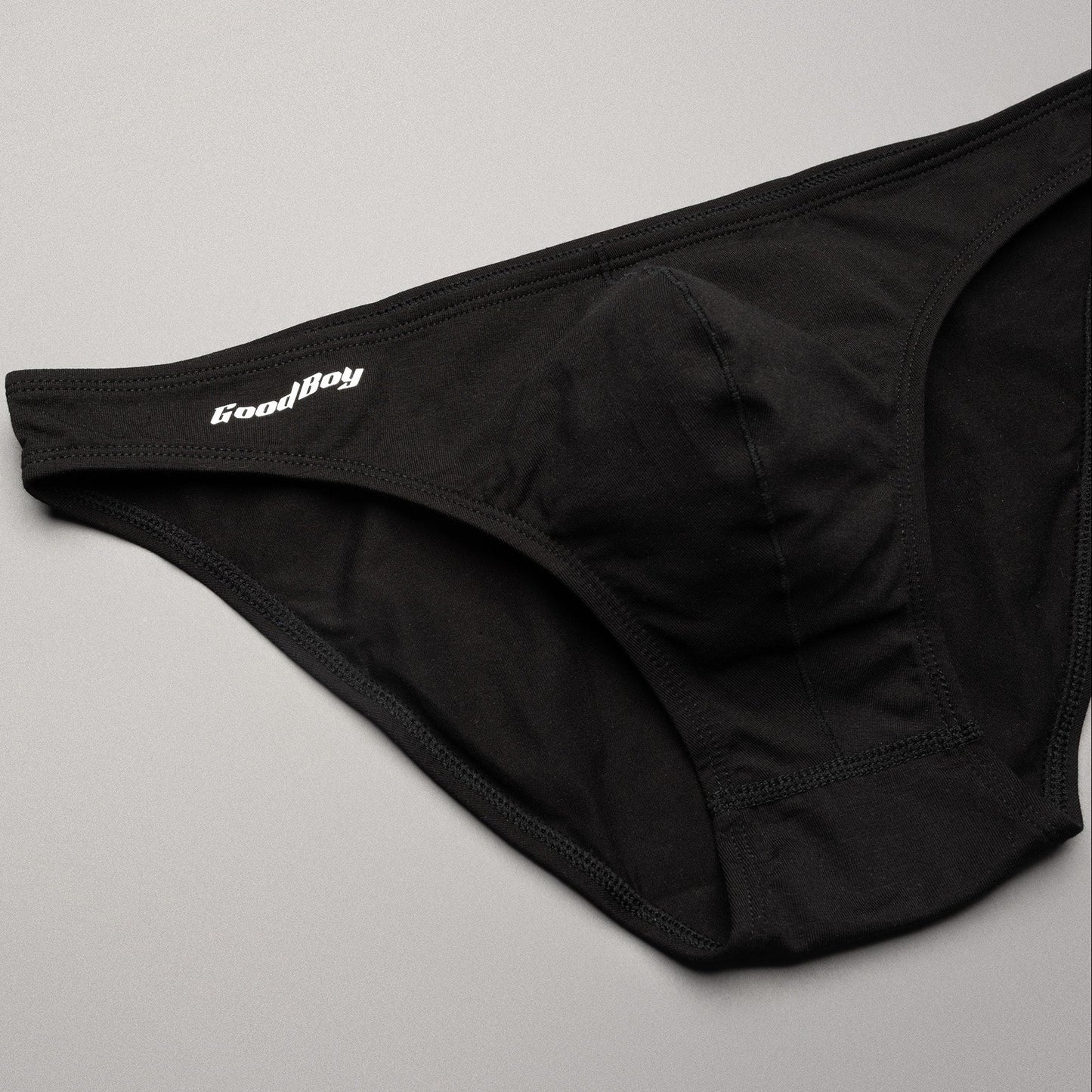 Black men's underwear with 'Good Boy' brand logo on a gray background