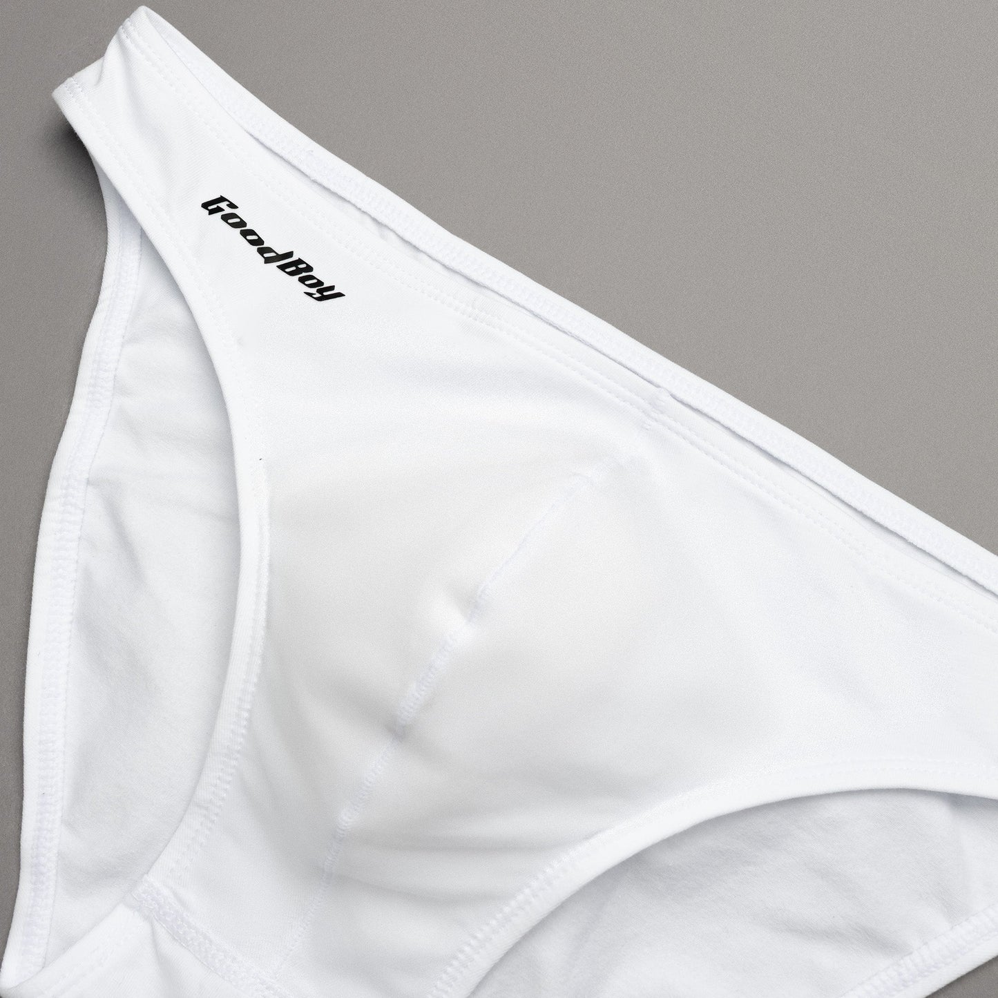 White underwear with 'Good Boy' brand logo on a gray background