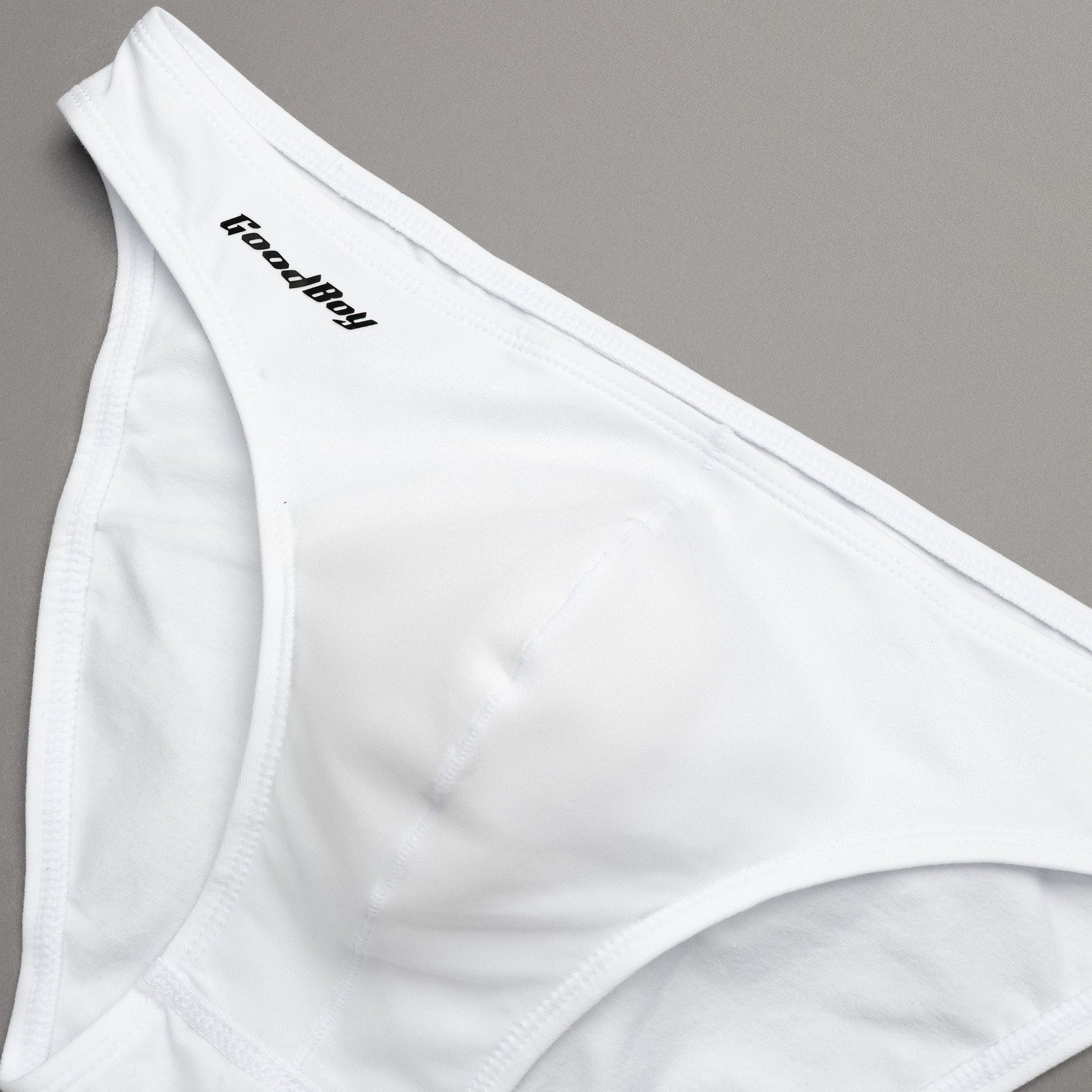White underwear with 'Good Boy' brand logo on a gray background