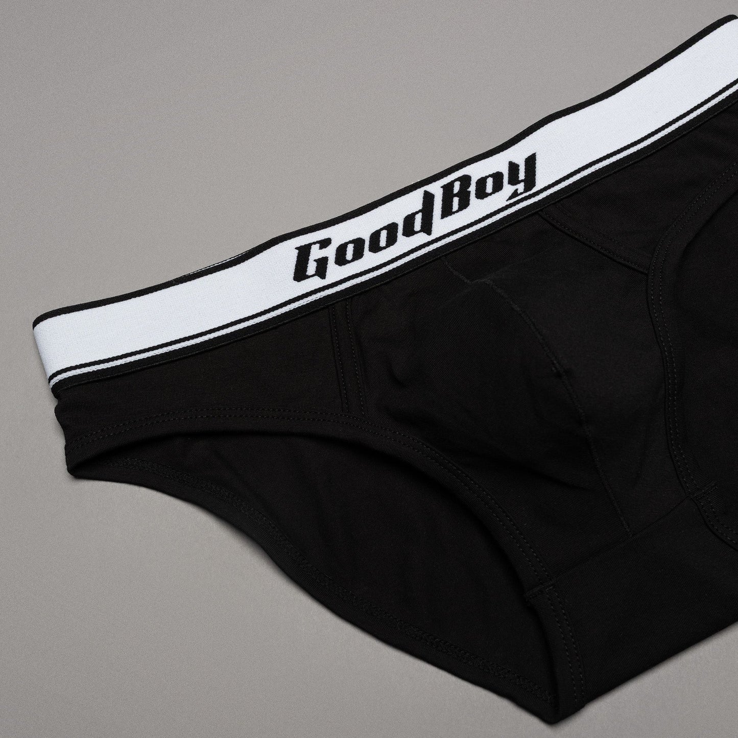 Black underwear with 'Good Boy' waistband on a gray background