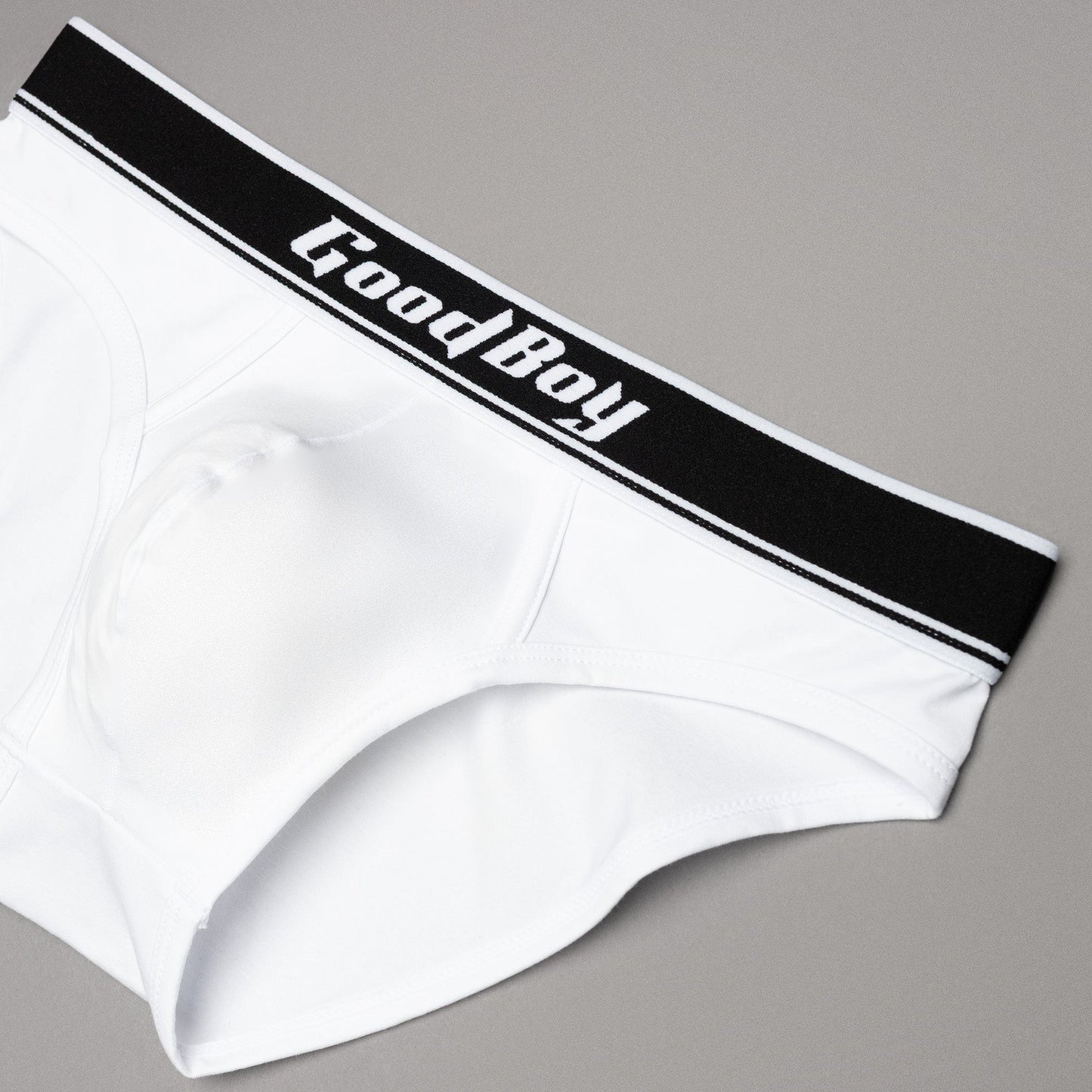 White underwear with black waistband featuring 'Good Boy' text on a gray background