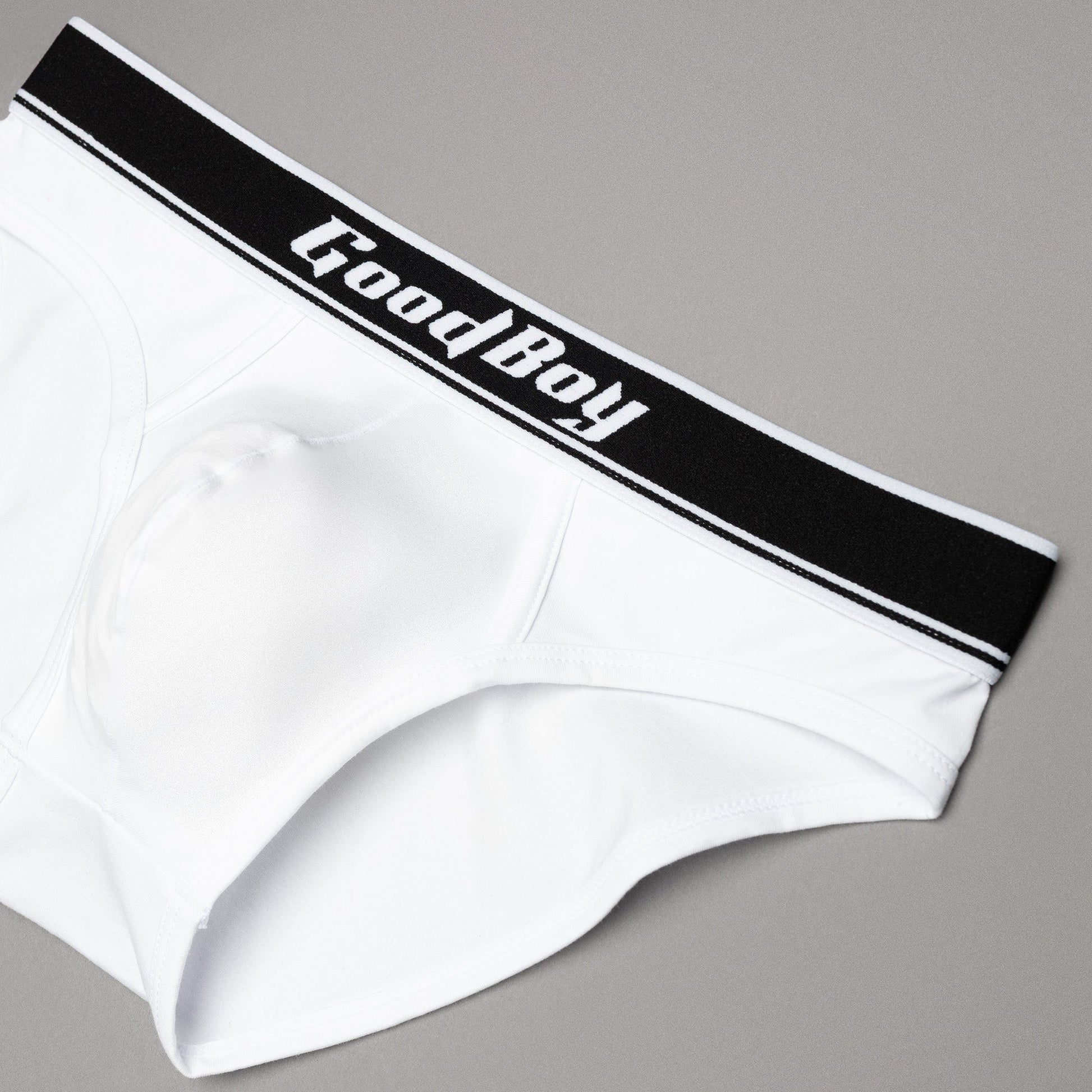 White underwear with black waistband featuring 'Good Boy' text on a gray background