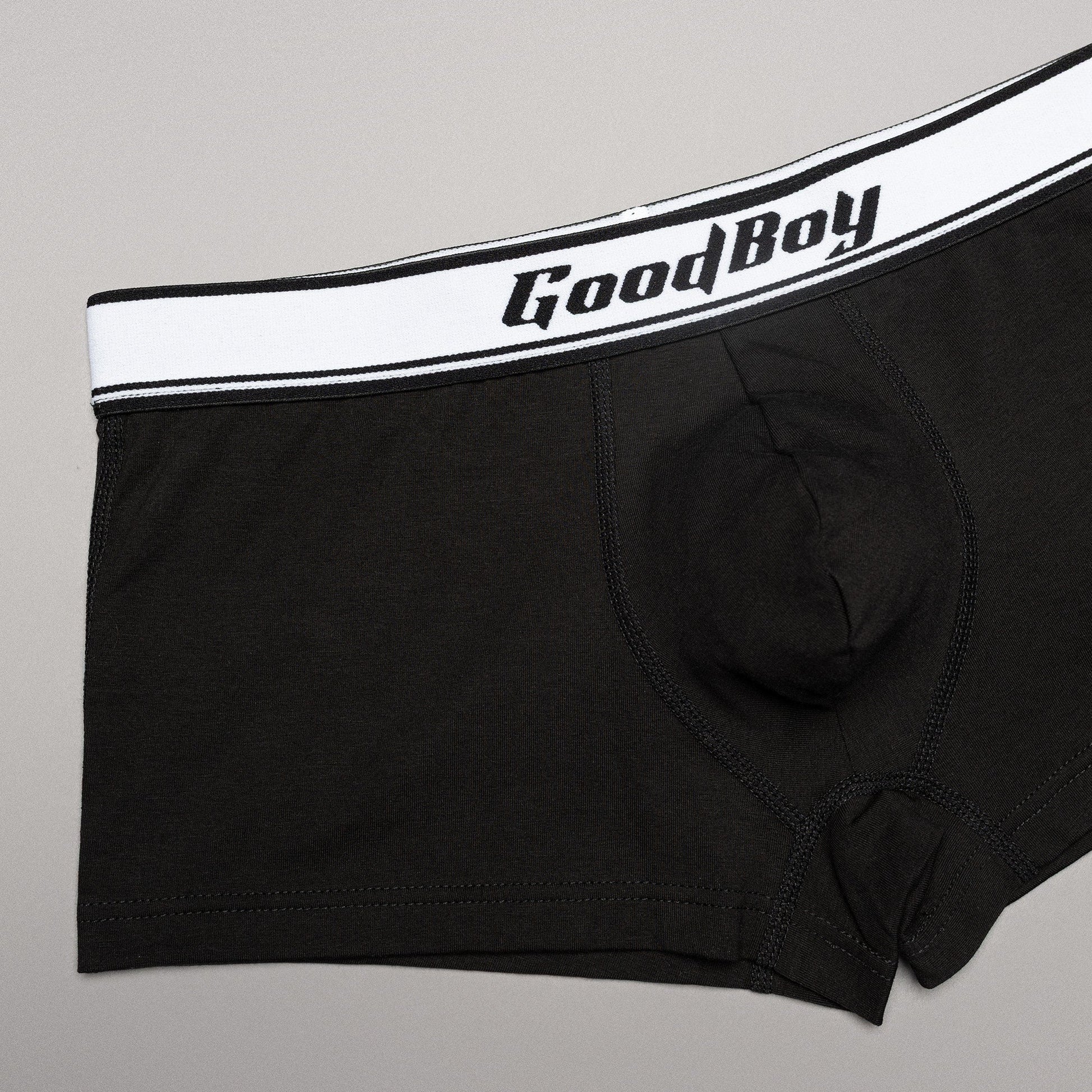 Black boxer briefs with a white waistband featuring 'Good Boy' logo on a gray background
