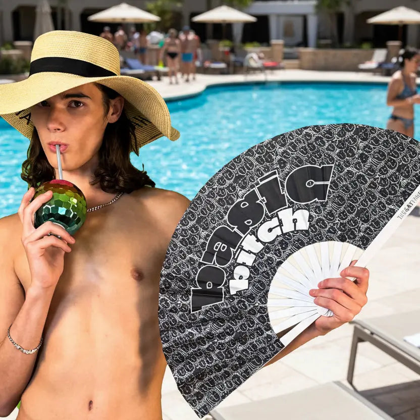 Person by a pool holding a drink and a branded fan, with a poolside background.