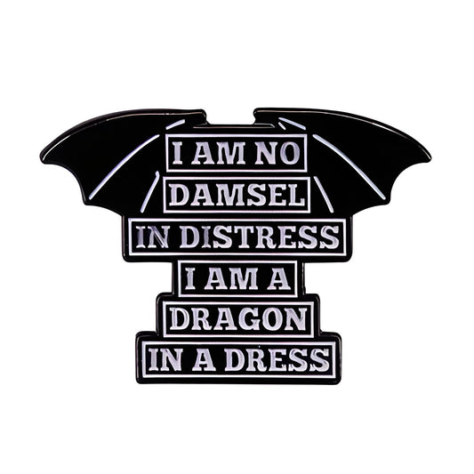 Black and white lapel pin with text 'I am no damsel in distress, I am a dragon in a dress' on a white background