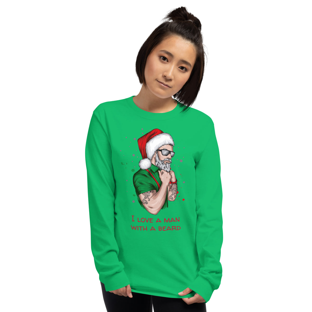 Person wearing a green long sleeve shirt with an image of a lumbersexual style santa wearing a green shirt, red suspenders, traditional santa hat, sunglasses, tattoos, and dark sunglasses and text in red that reads ' i love a man with a beard'