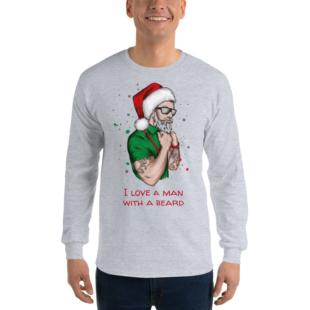 person wearing a grey long sleeve shirt with an image of a lumbersexual style santa wearing a green shirt, red suspenders, traditional santa hat, sunglasses, tattoos, and dark sunglasses and text in red that reads ' i love a man with a beard'