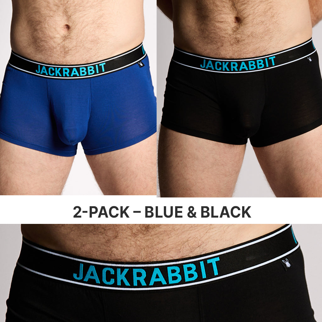 Two pairs of Jackrabbit boxer briefs, one blue and one black, on a plain background.