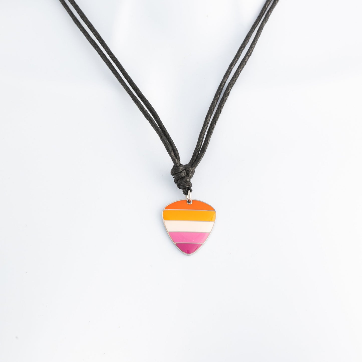 Necklace with a lesbian pride guitar pick pendant on a white background