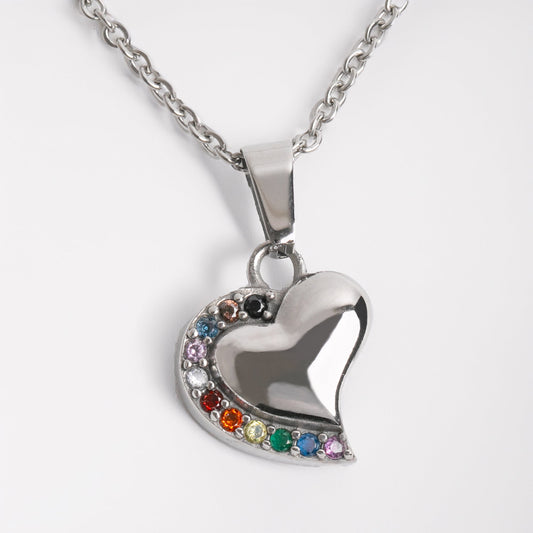 Heart-shaped pendant with rainbow stones on a white background