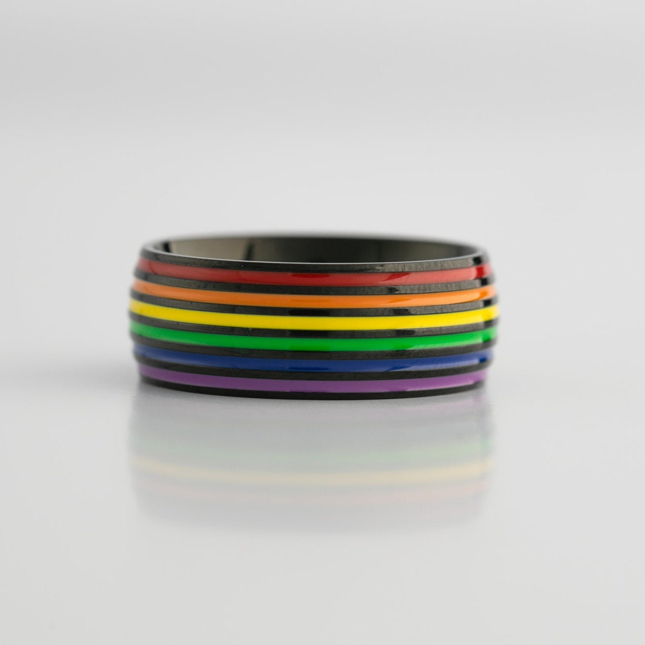 Black ring with lgbtq pride rainbow stripes on a white background