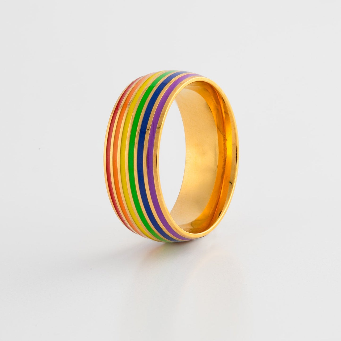 Ring with lgbt pride rainbow gold band  on a light gray background