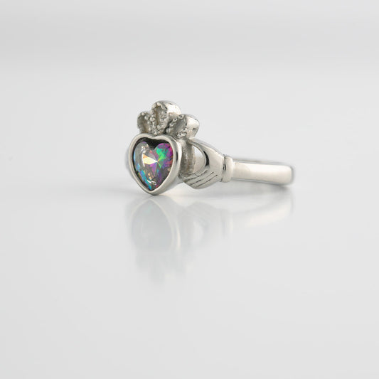 Silver ring with heart-shaped topaz gemstone with a colorful gem on a white background