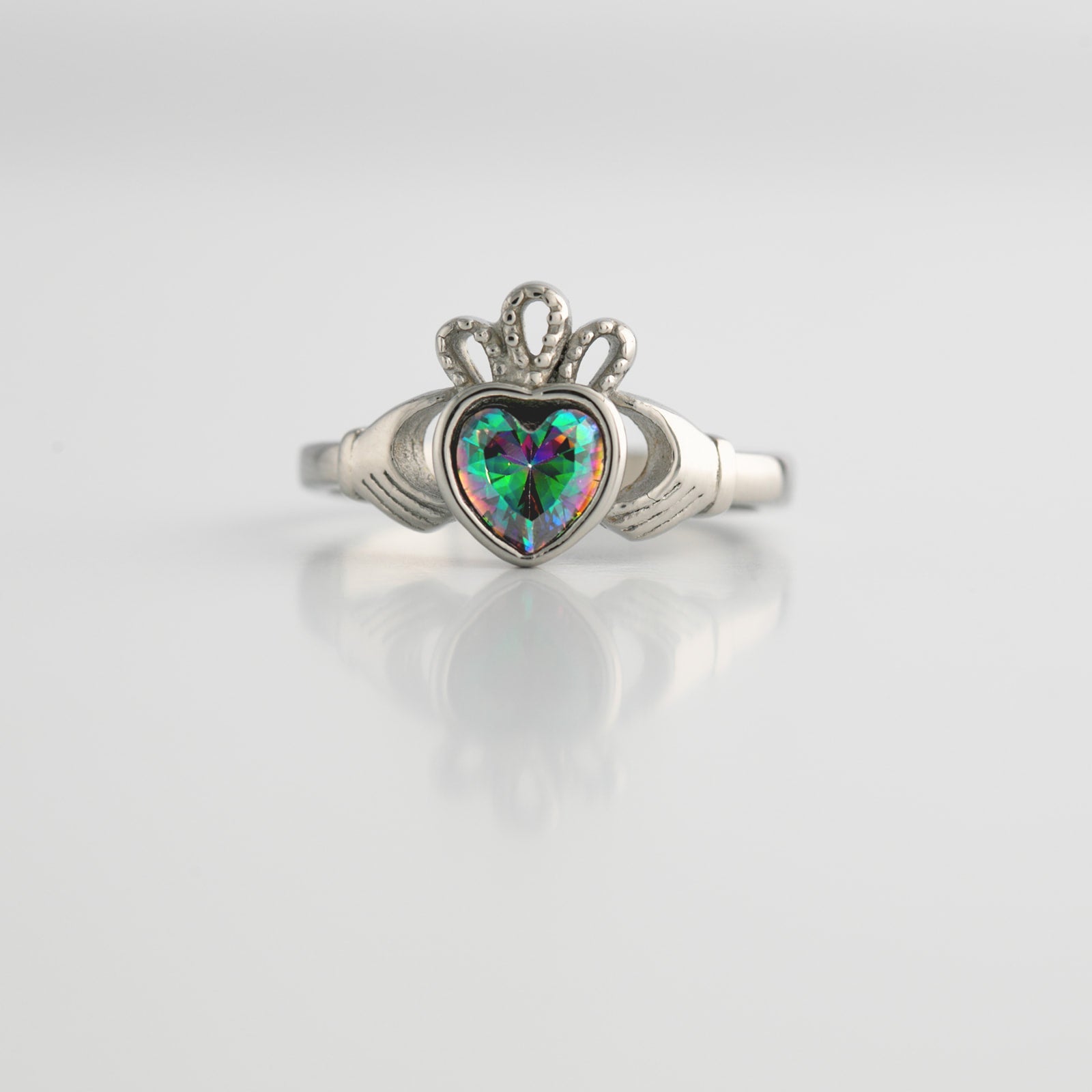 Silver ring with a heart-shaped topaz on a light gray background