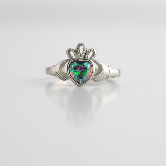 Silver ring with a heart-shaped topaz on a light gray background