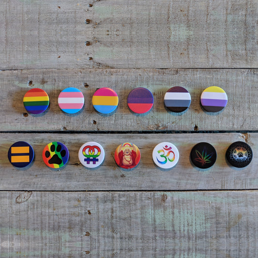 Collection of colorful cell phone stands with various symbols on a wooden surface