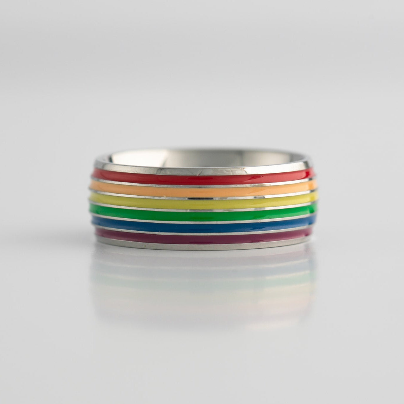 Ring with lgbtq pride rainbow stripes on a light gray background