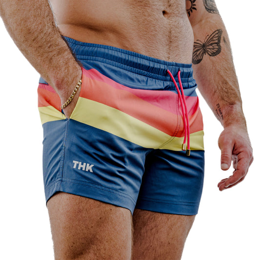 Multicolored swim shorts with 'THK' branding on a white background