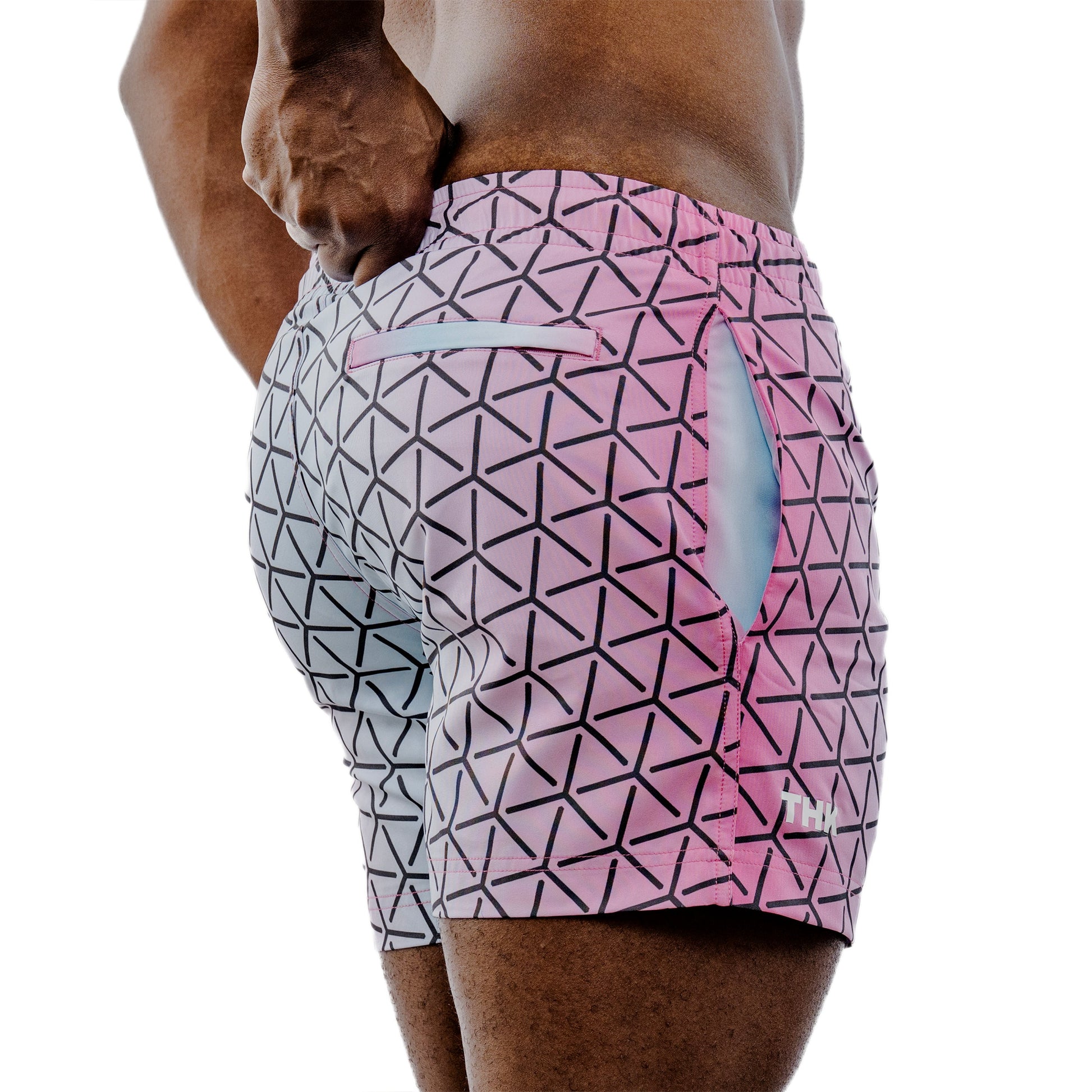 Geometric patterned shorts worn by a person on a white background