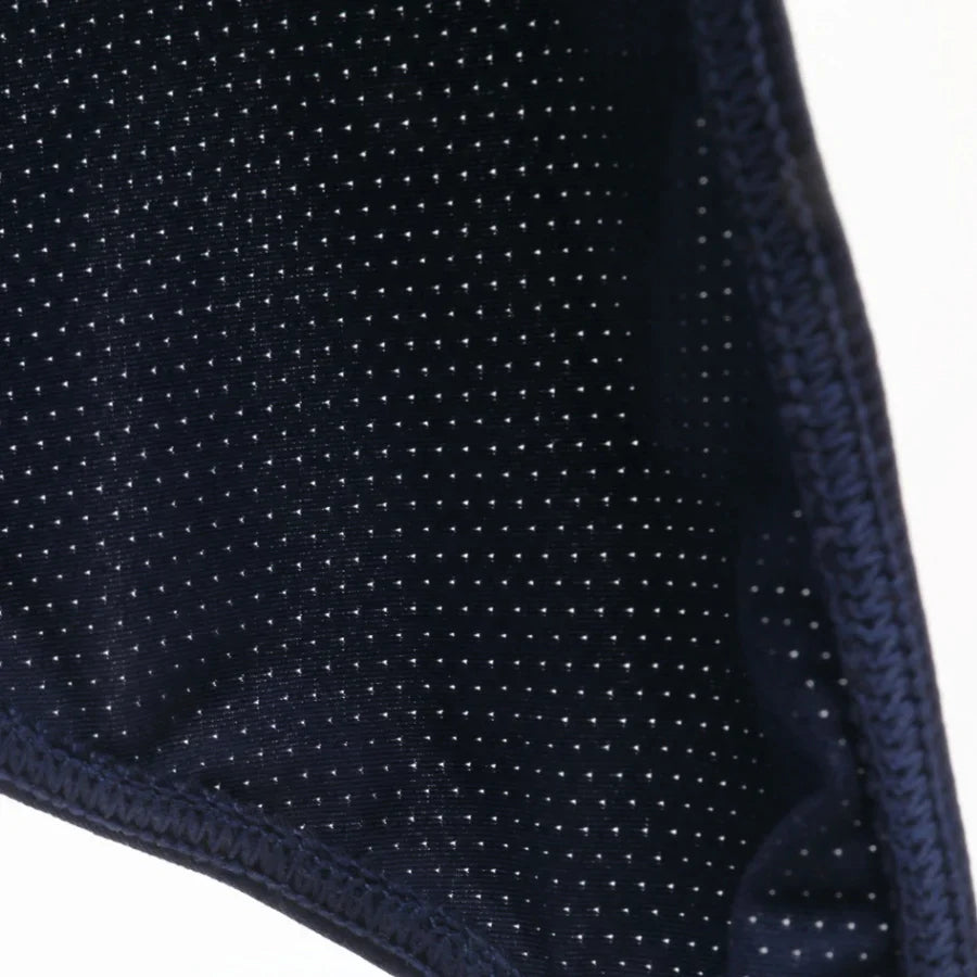 Close-up of a dark blue fabric with a subtle pattern on a white background