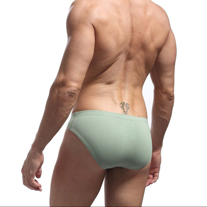 Man wearing a green men's underwear on a white background