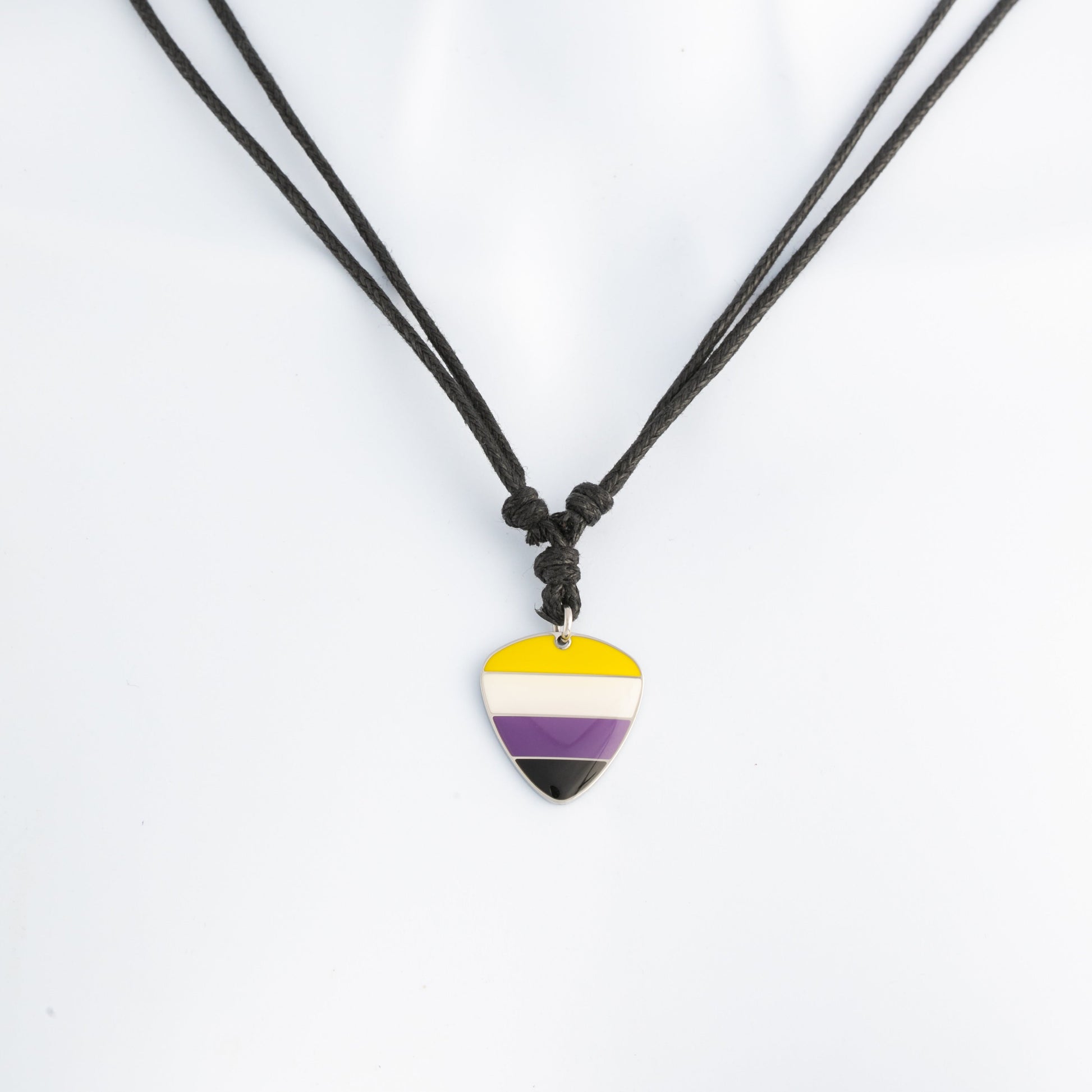Necklace with a nonbinary pride colored guitar pick pendant on a white background
