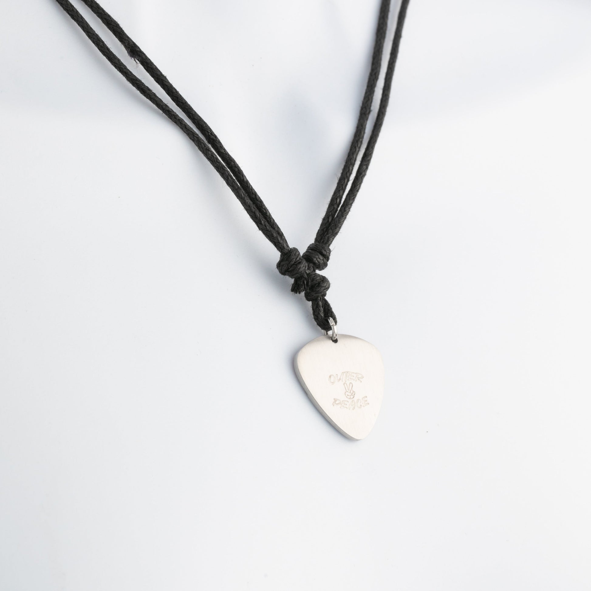 Necklace with a guitar pick pendant on a white background