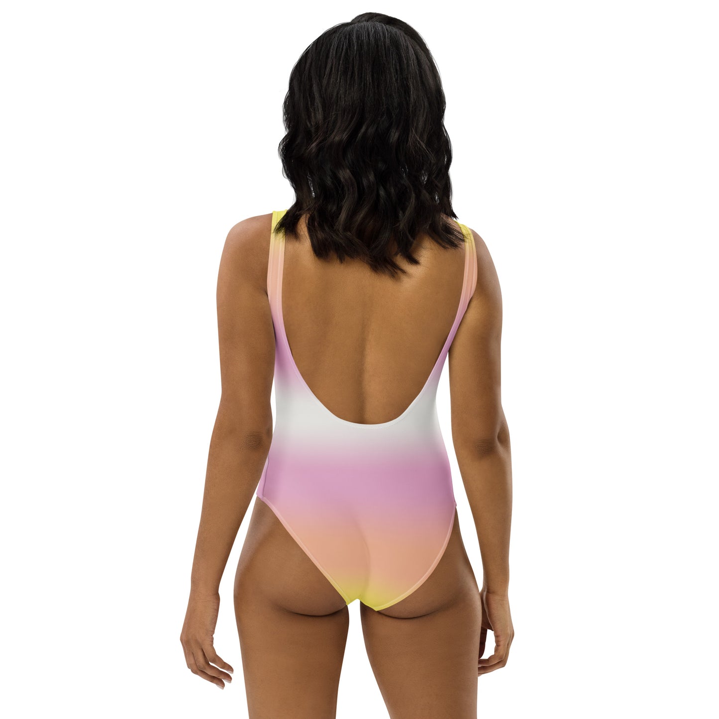 Woman wearing a colorful one-piece swimsuit on a white background