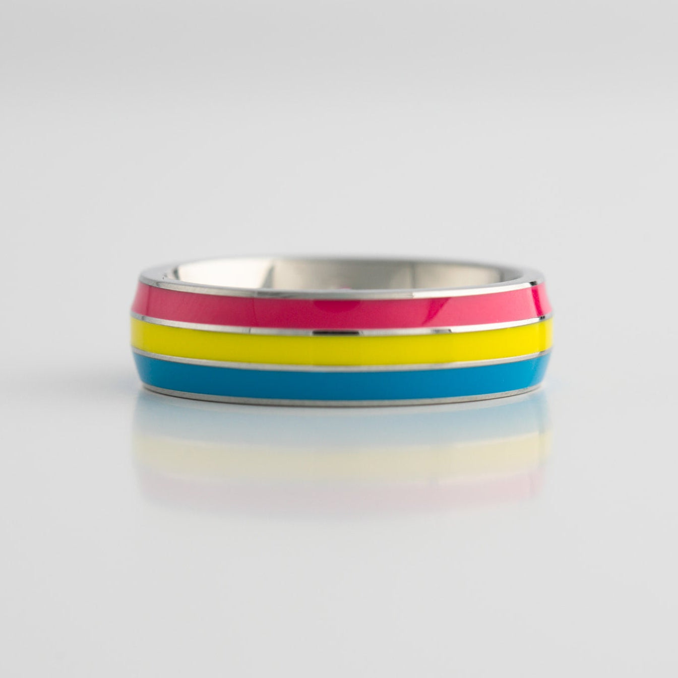 Ring with pansexual pride stripes on a white background
