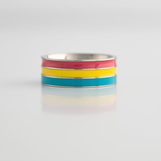 Ring with pansexual pride colored stripes on a light gray background