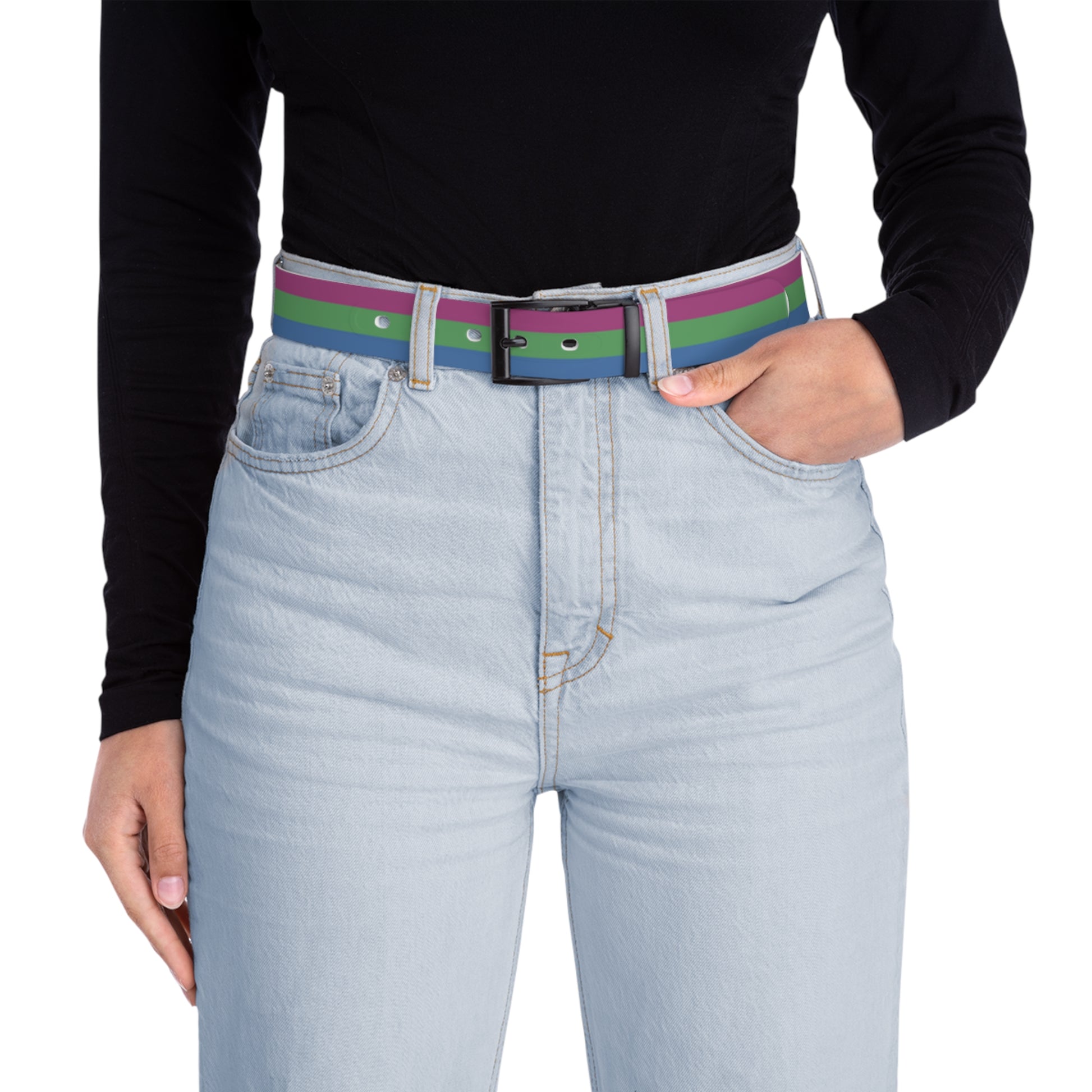 Person wearing a polysexual pride belt with a black shirt and light blue jeans on a white background