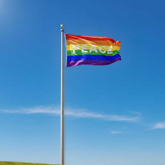 A rainbow pride flag with the word 'PEACE' in white letters flying on a silver flagpole against a bright blue sky.
