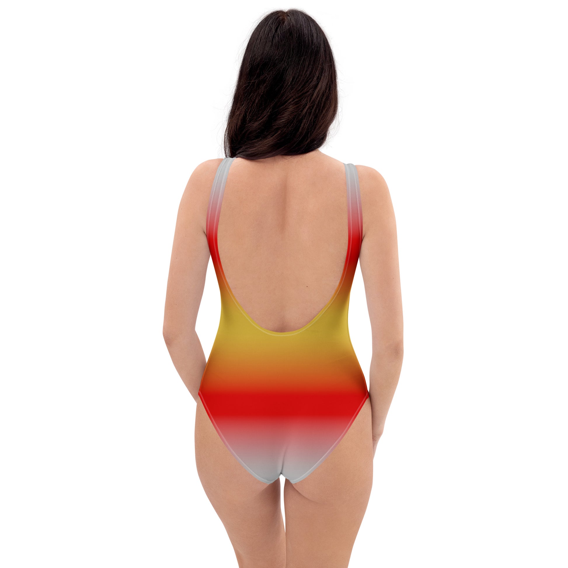 Woman wearing a colorful one-piece swimsuit with a gradient design on a white background