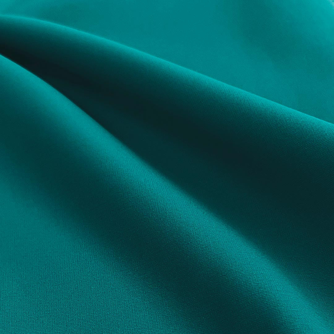 Close-up of teal fabric with folds