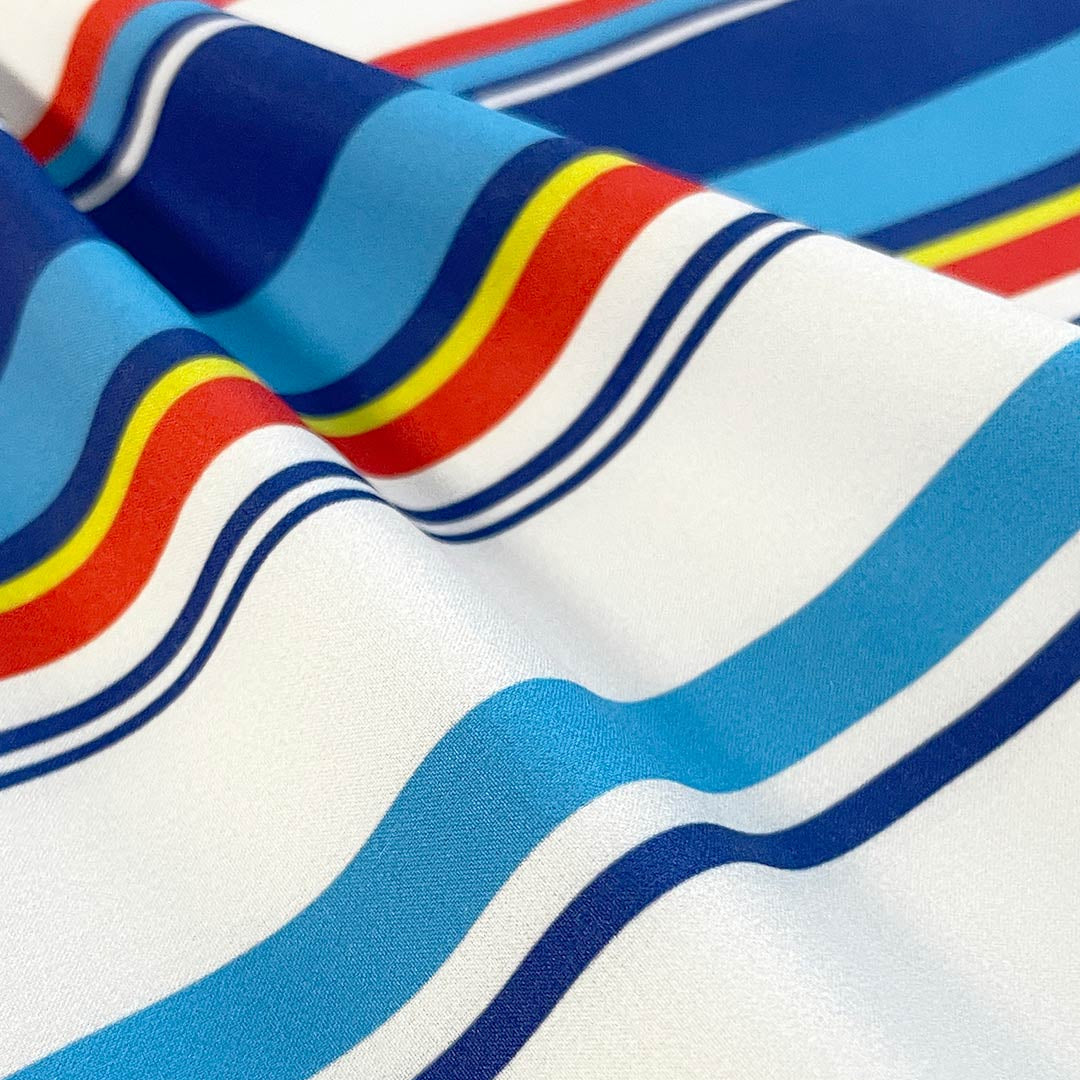 Close-up of fabric with red, blue, and white wavy stripes.