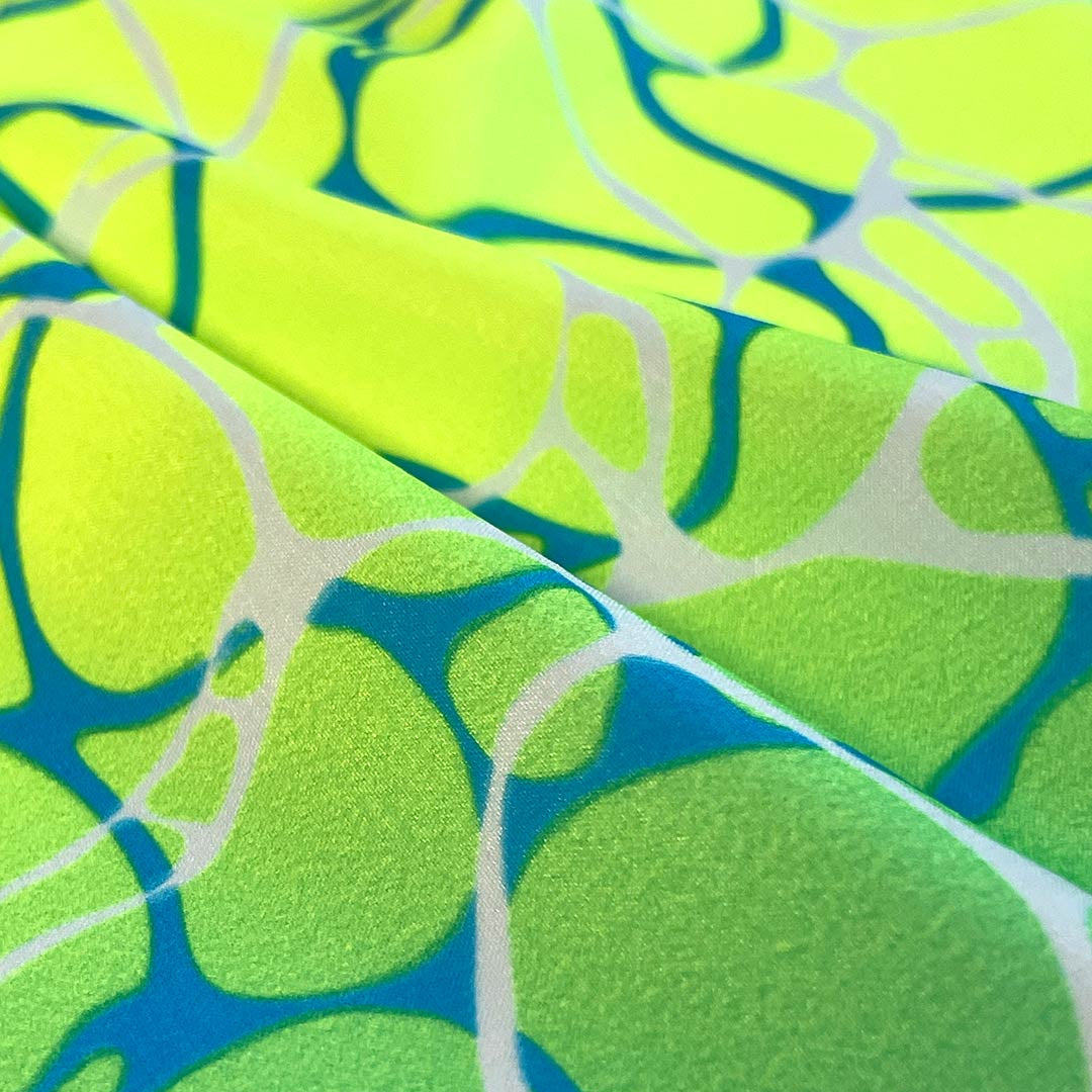 Close-up of a fabric with a green and blue abstract pattern