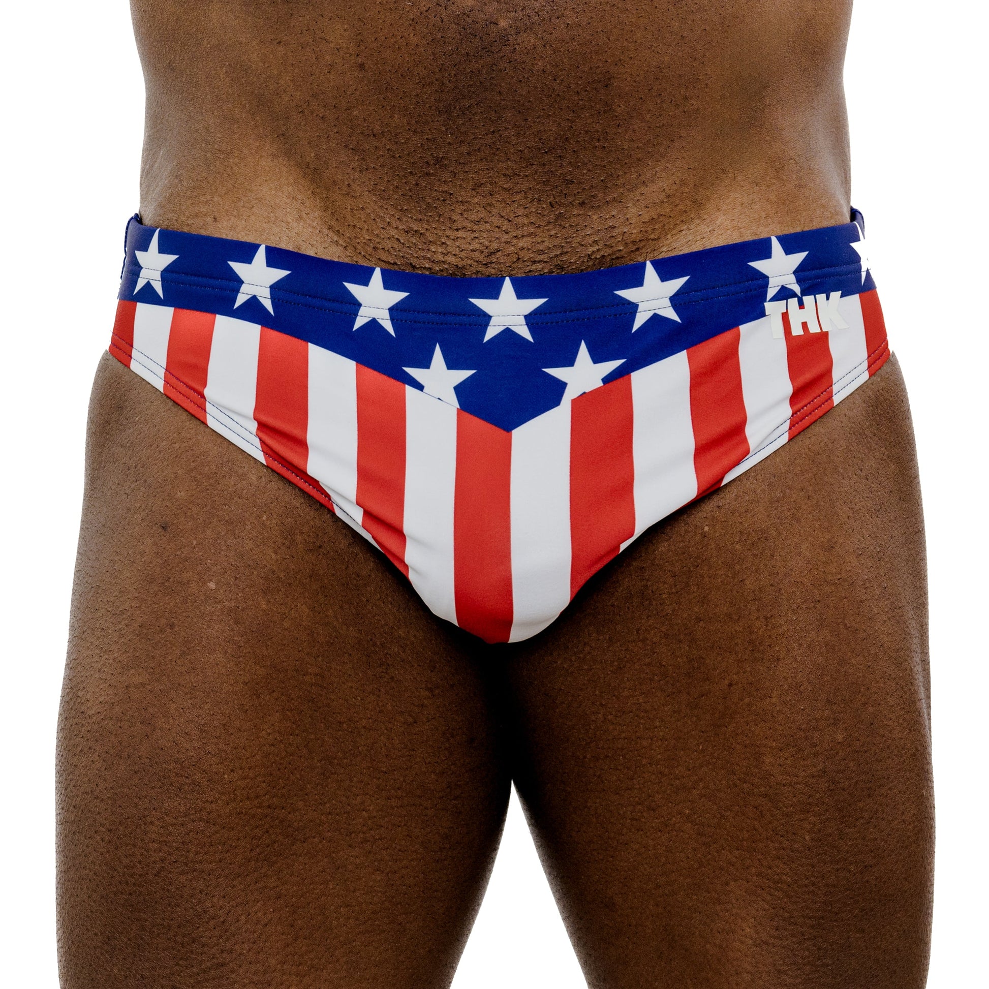 Red, white, and blue swim briefs with star pattern on a white background