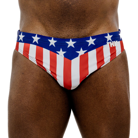 Red, white, and blue swim briefs with star pattern on a white background
