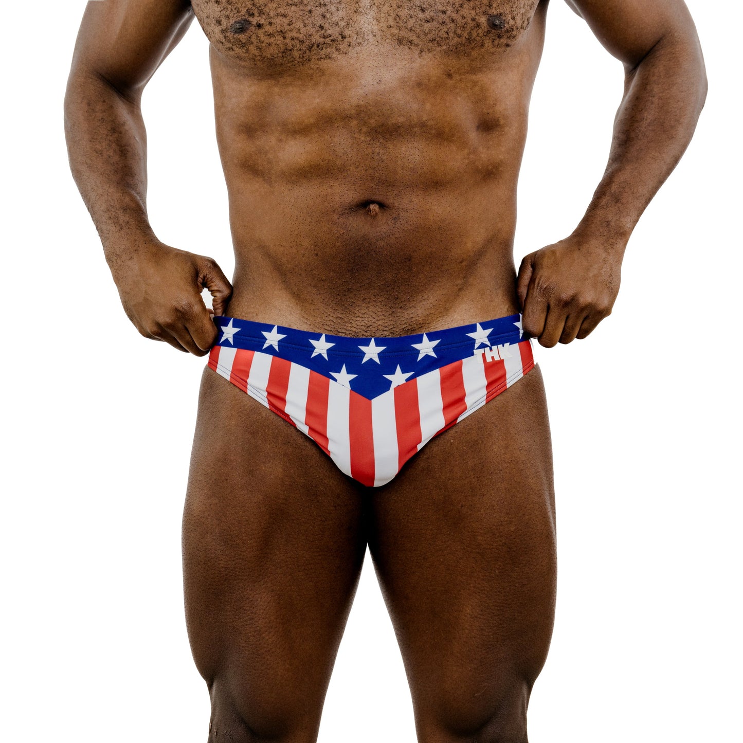 Person wearing a red, white, and blue speedo with American flag design on a white background