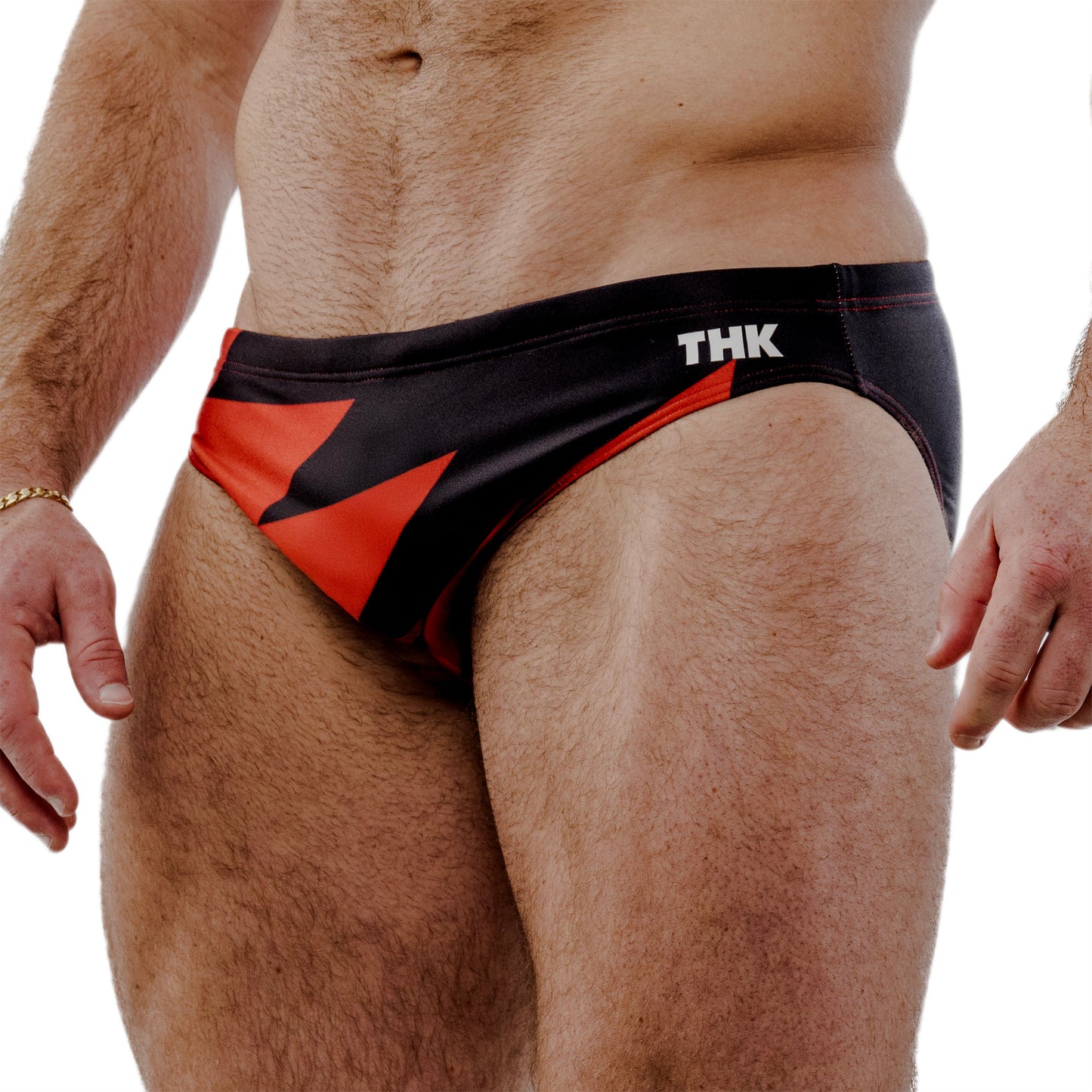 Red and black speedo with 'THK' branding on a white background