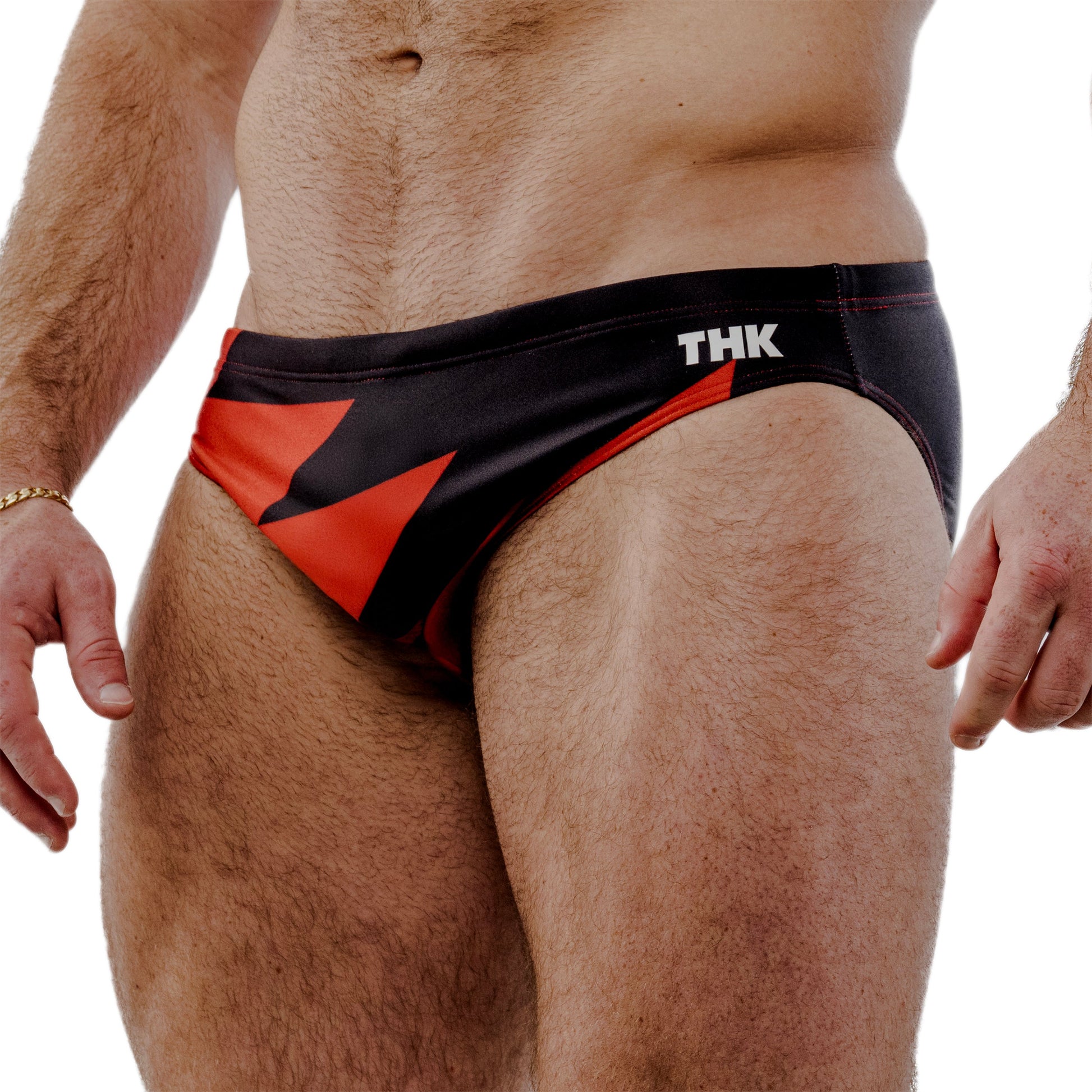 Red and black speedo with 'THK' branding on a white background