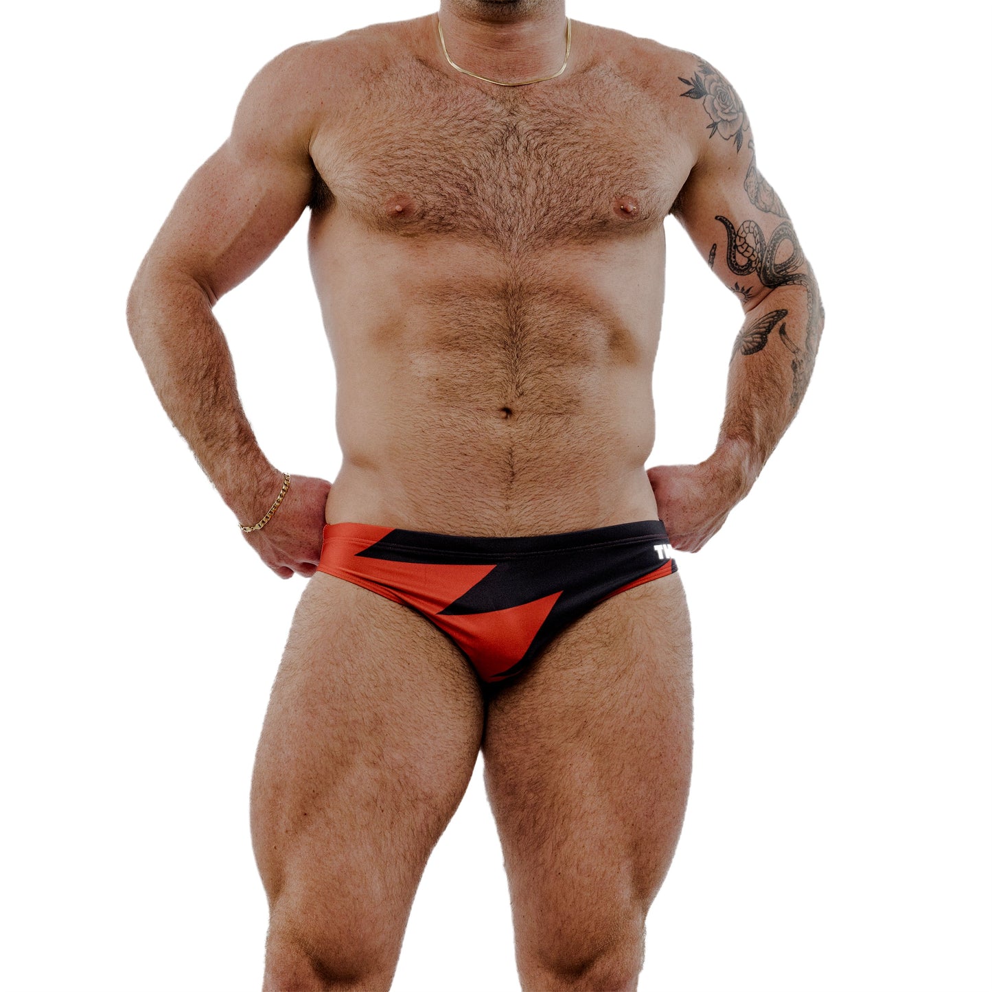 Man wearing a red and black swimsuit on a white background