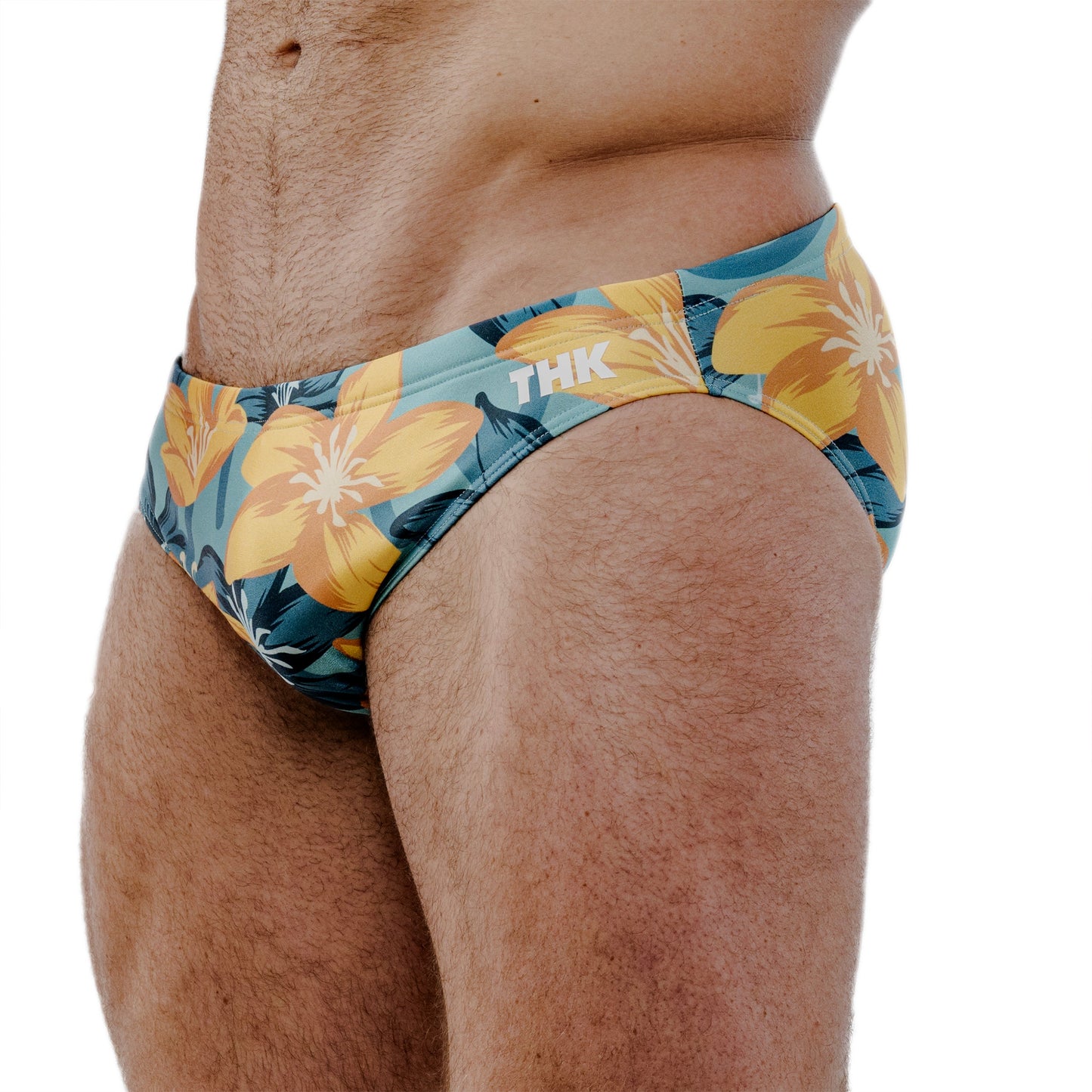 Tropical floral speedos with 'THK' branding on a white background