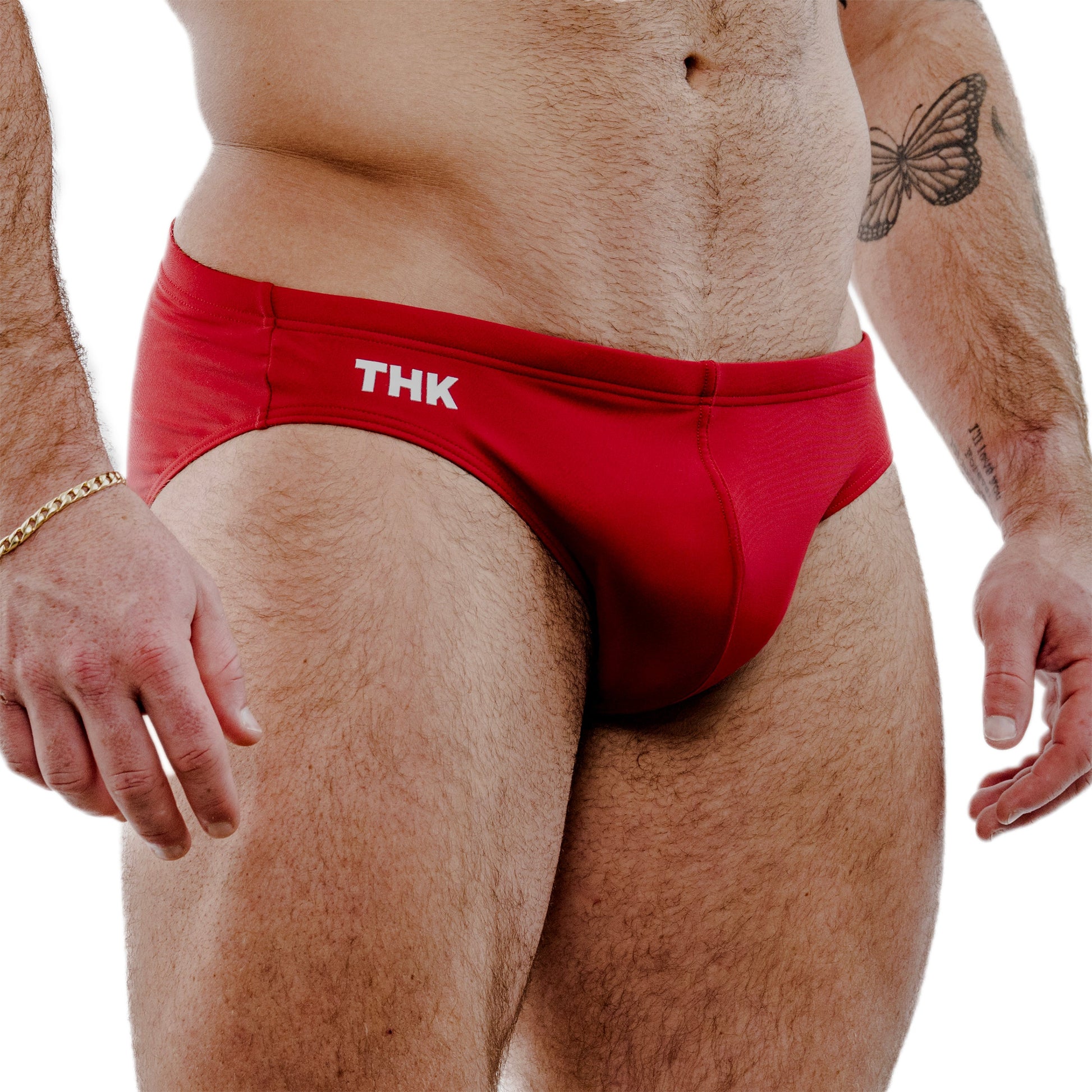 Red swim briefs with 'THK' branding on a white background