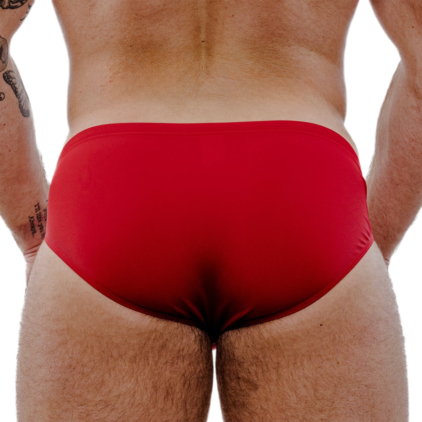 Red swim briefs worn by a person on a white background